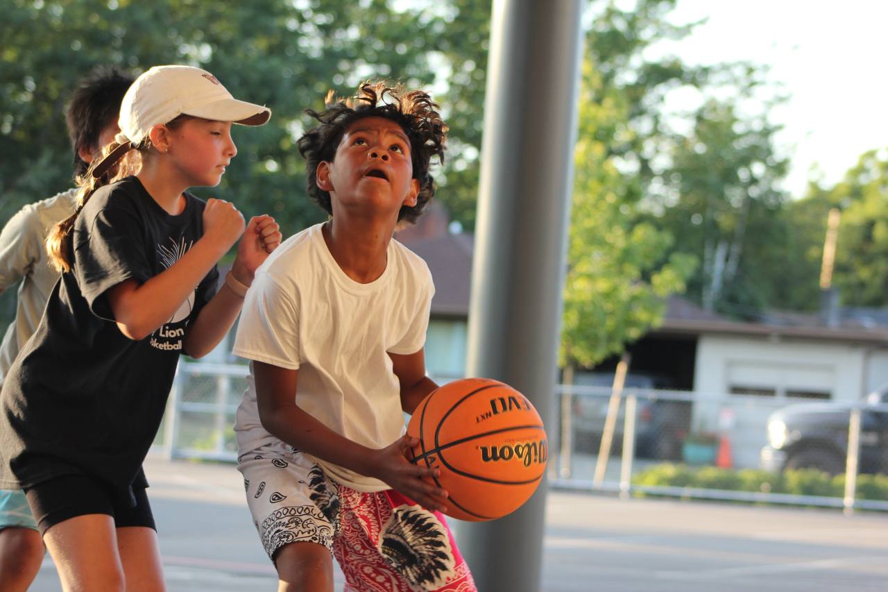 Two young players concentrating during a basketball drill